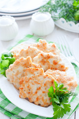 Chopped cutlets of turkey fillet with fresh herbs on a white plate, selective focus