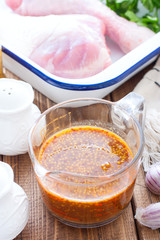 Honey mustard marinade in a transparent glass on a wooden table, selective focus
