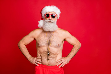 Portrait of his he nice attractive handsome content sporty muscular bearded virile gray-haired macho hands on hips spa resort trip rescue save isolated on bright vivid shine red background