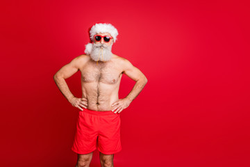 Portrait of his he nice attractive handsome funky content sporty muscular beadred gray-haired man hands on hips trip tour international tourism isolated over bright vivid shine red background