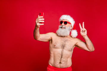 Fototapeta na wymiar Portrait of his he nice attractive handsome funky cheerful cheery positive glad gray-haired man taking making selfie showing v-sign isolated over bright vivid shine red background
