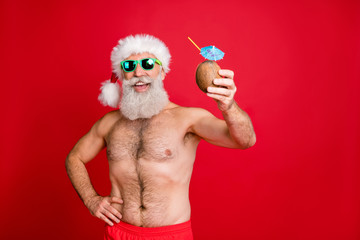 Portrait of his he nice attractive cheerful cheery funky gray-haired man enjoying leisure having fun drinking fresh tasty juice rest relax toast cheers isolated over bright vivid shine red background