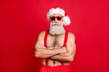 Fototapeta na wymiar Portrait of his he nice attractive content calm gray-haired strong hot muscular macho St Nicholas folded arms festal costume isolated over bright vivid shine red background