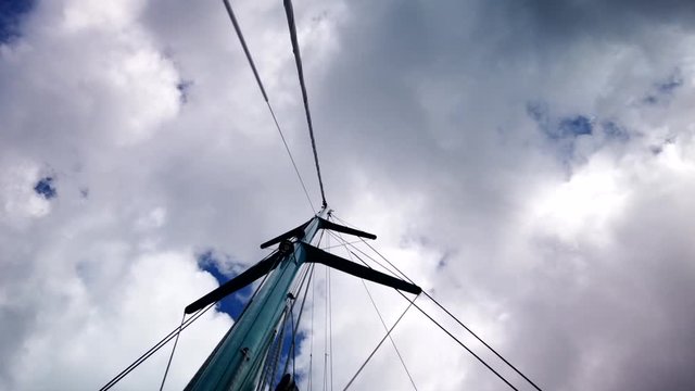 A timelapse of a mast and sky with clouds from below