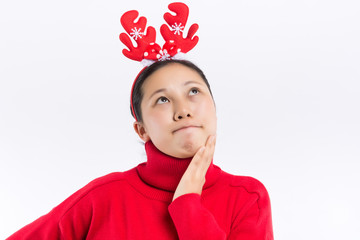 Funny young Santa girl in Christmas hat keeping mouth wide open, jumping spreading hands and legs...
