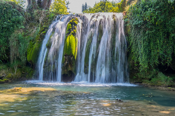 Fototapeta premium Scenic waterfall cascades on the river Sluncica. Magnificent Southern Europe, Croatia, small town Slunj. Beautiful day. The concept of ecological, active and photo tourism