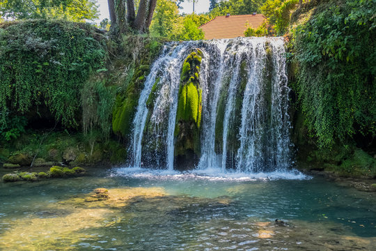 Scenic waterfall cascades on the river Sluncica. Magnificent Southern Europe, Croatia, small town Slunj. Beautiful day. The concept of ecological, active and photo tourism