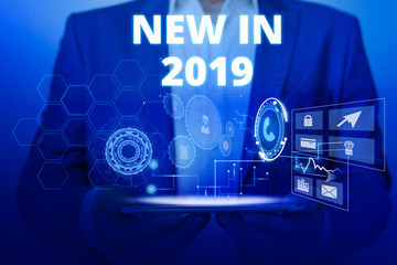 Text sign showing New In 2019. Business photo text what will be expecting or new creation for the year 2019 Male human wear formal work suit presenting presentation using smart device