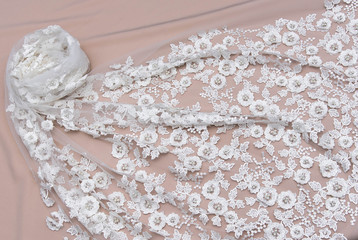Texture lace fabric. lace on white background studio. thin fabric made of yarn or thread. a background image of ivory-colored lace cloth. White lace on beige background.