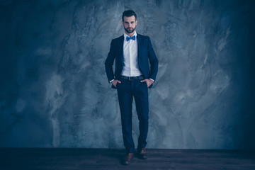 Full lenth photo of charming man putting his hands in pockets wearing blazer jacket pants trousers isolated over grey background