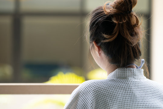 Close up Woman whow wear bathrobe turn back to outside of the bedroom in Thailand resort.