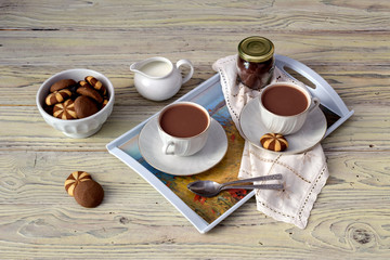 Cups with cocoa on a wooden table