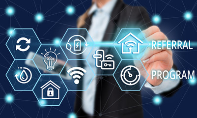 Text sign showing Referral Program. Business photo showcasing employees are rewarded for introducing suitable recruits Female human wear formal work suit presenting presentation use smart device