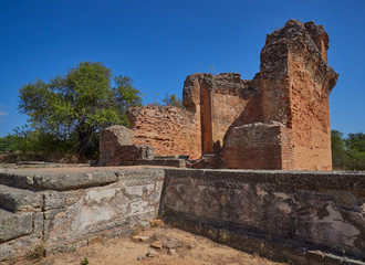 One of the Baths of the Bathing and Spa Complex with its decorative Mosaics and the Water Temple overlooking it at the Roman Ruins of Milreu in Portugal.