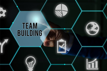 Fototapeta premium Text sign showing Team Building. Business photo showcasing various types of activities used to enhance social relations Male human wear formal work suit presenting presentation using smart device