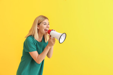 Screaming woman with megaphone on color background