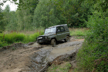 Fototapeta na wymiar Car SUV 4x4 stuck in a puddle with mud, stalled.