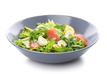 Plate of tasty fresh salad with quail eggs on white background