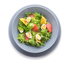 Plate of tasty fresh salad with quail eggs on white background