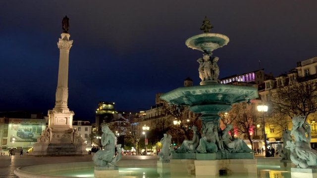 Illuminated fountain in Rossio Square in Lisbon, Portugal. Taken at night