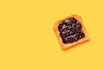 Tasty toasted bread with jam on color background