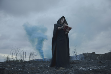 Man reciting quotes from book with blue smoke effects
