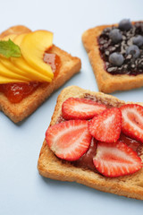 Different tasty sandwiches on color background