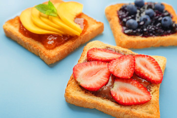 Different tasty sandwiches on color background