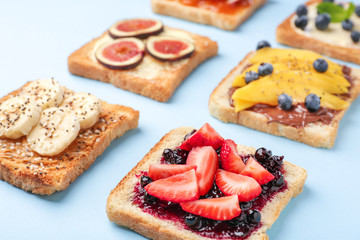 Different tasty sandwiches on color background
