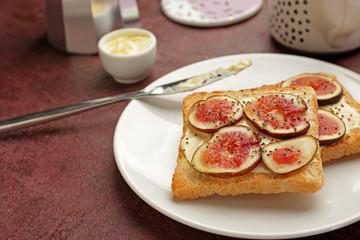 Plate with tasty sandwiches on table