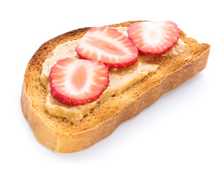 Tasty toasted bread with strawberry and peanut butter on white background