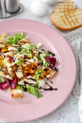 Plate with tasty salad on table, closeup