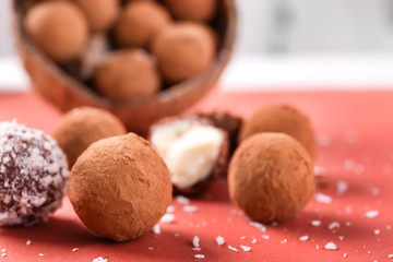 Tasty sweet truffles on color table, closeup