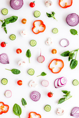 Sliced, cut, chopped vegetables pattern on white background top view