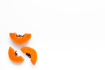 Sliced papaya on white background top view space for text
