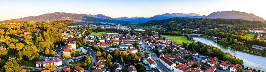 Aerial of old bavarian town Bad Toelz in Bavaria. ISar River is running through the CIty. Alps Mountains in the back. Sunset