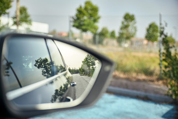 view of the exterior mirror of a car while driving