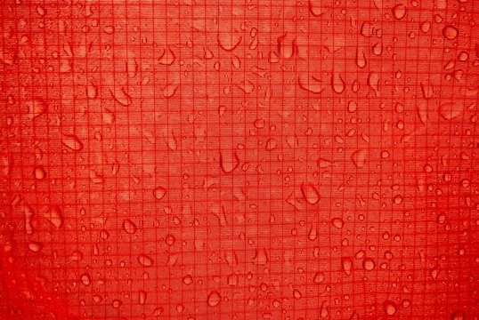 red tent close-up, strong and durable material of long-lasting tourist equipment and sportswear