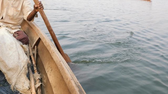 Old Fisherman Paddle on Wooden Boat. Travel Adventure Vacation Nature Concept 4K Slowmotion Footage. Bagan, Myanmar.