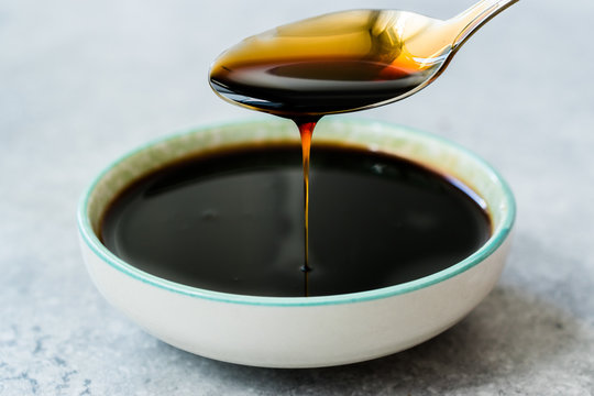 Organic Black Cane Sugar Molasses Dripping from Spoon
