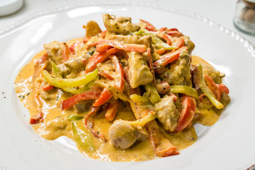 Curry Chicken with Cream, Mustard and Julienne Vegetables served with Plate.