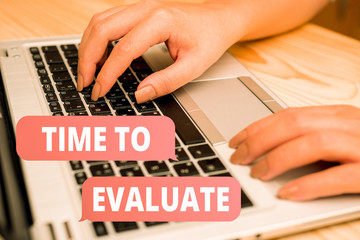 Handwriting text writing Time To Evaluate. Conceptual photo judge something with respect to its worth or significance woman laptop computer smartphone mug office supplies technological devices