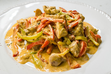 Curry Chicken with Cream, Mustard and Julienne Vegetables served with Plate.