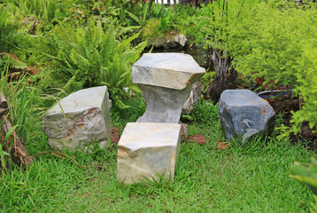 Marble stone bench set in the garden. Stone furniture.