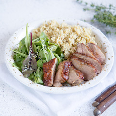 healthy lunch. Serving Couscous with Salad and Roasted Duck Breasts