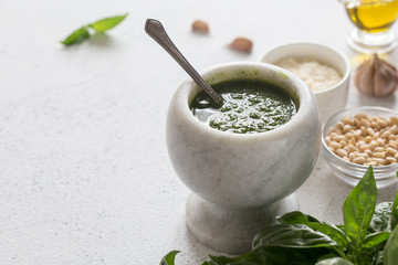 Homemade basil pesto sauce and ingredients. Vegan healthy food.