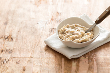 white Bowl of oats porridge. Healthy oatmeal breakfast