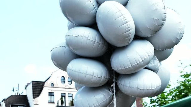 Large white balloons on city sky background. 4K