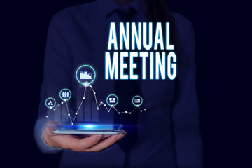 Text sign showing Annual Meeting. Business photo text yearly meeting of the general membership of an organization Woman wear formal work suit presenting presentation using smart device