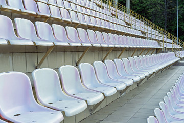 Plastic seats in the stadium. Tribune fans. Seats for spectators in the stadium.